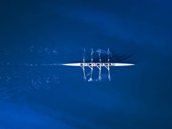 Aerial View Of A Rowing Boat Surrounded By Classic Blue Water