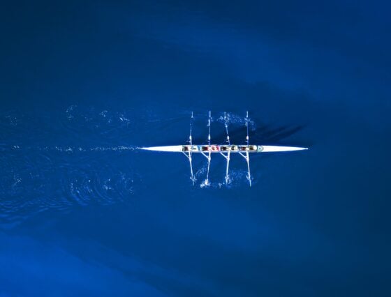 Aerial View Of A Rowing Boat Surrounded By Classic Blue Water